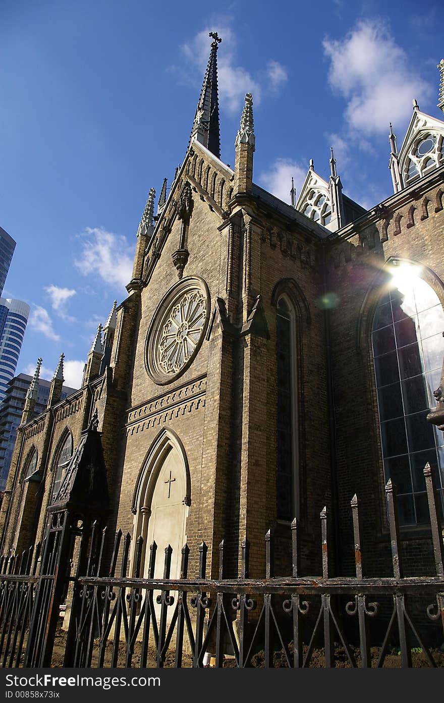 Side view of a gothic architecture church against a blue sky background