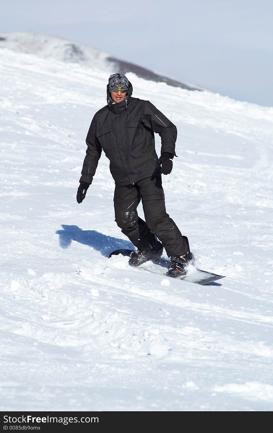 Black snowboarder on ski resort