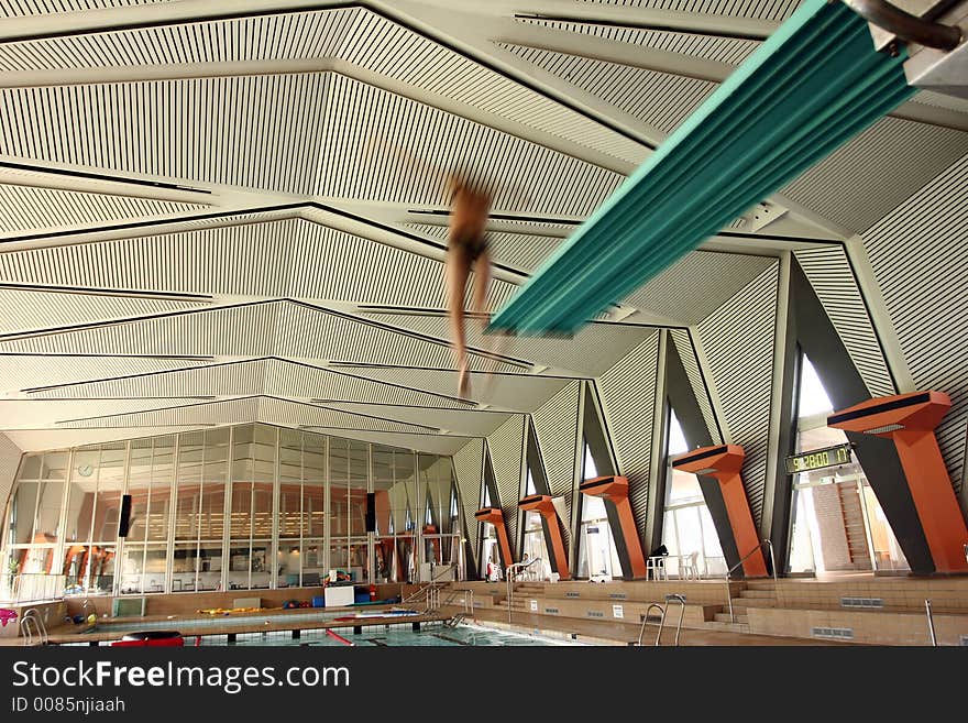 Indoor swimming pool fun, girl diving