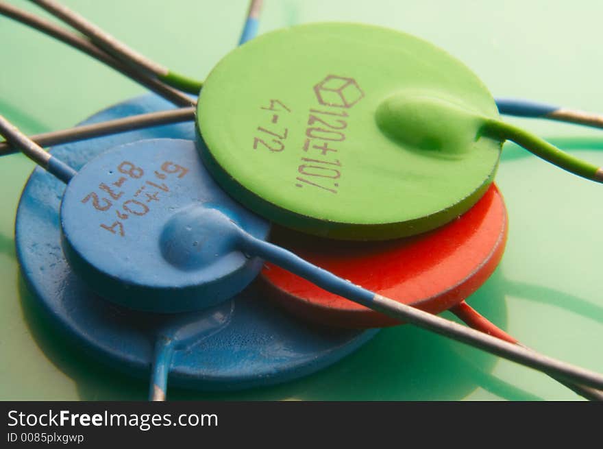 Color condensers on green glossy background