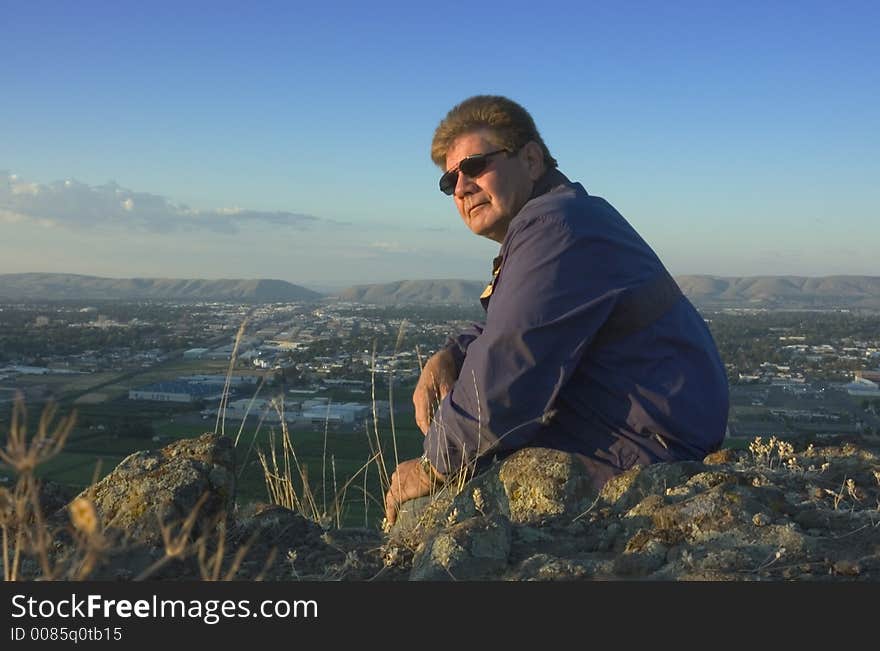 One adult on top of mountain overlooking the Yakima valley in Washington state. One adult on top of mountain overlooking the Yakima valley in Washington state