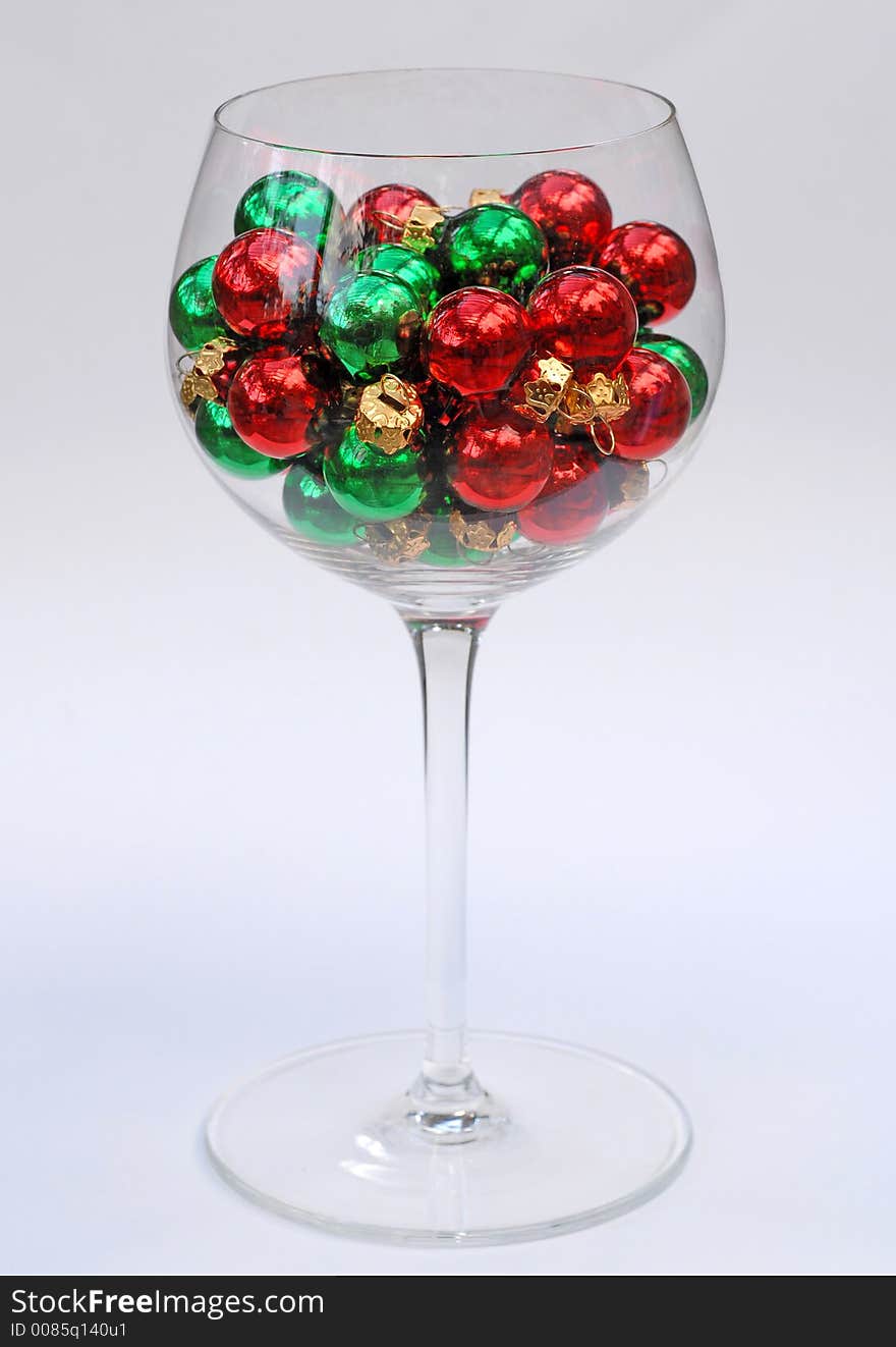 Christmas ornaments in a wine glass. Christmas ornaments in a wine glass.