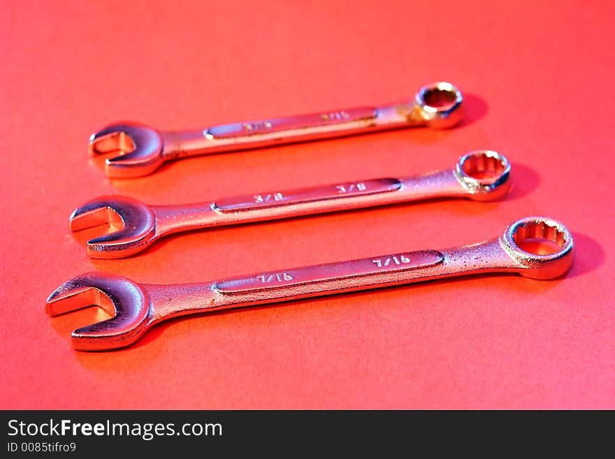 Three Wrench tools on red background