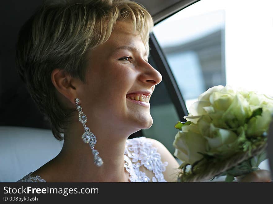 The laughing bride in the car. The laughing bride in the car