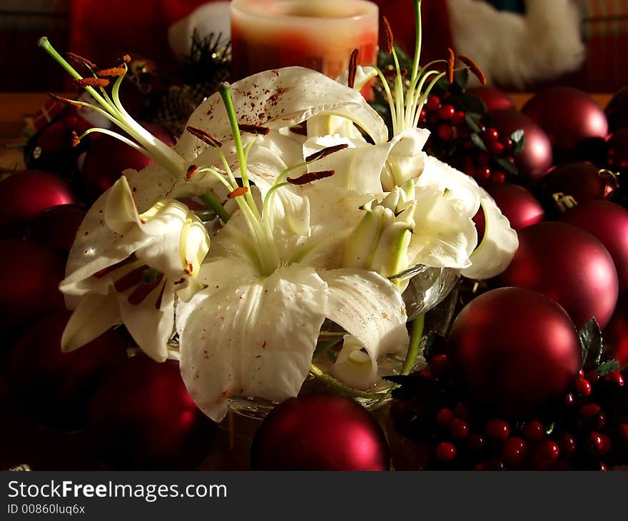 Christmas flowers surrounded by red ornaments