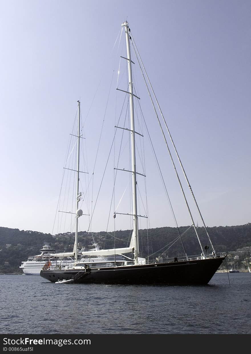 Two mast mega sailing yacht moored in a bay. Two mast mega sailing yacht moored in a bay