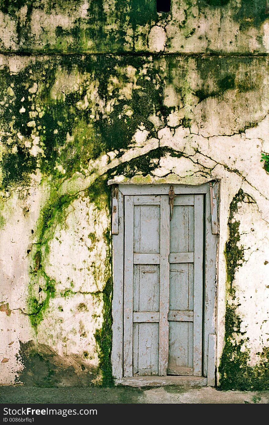 This image is taken during heavy monsoon days in Maharashtra state. Old door with green wall. This image is taken during heavy monsoon days in Maharashtra state. Old door with green wall.