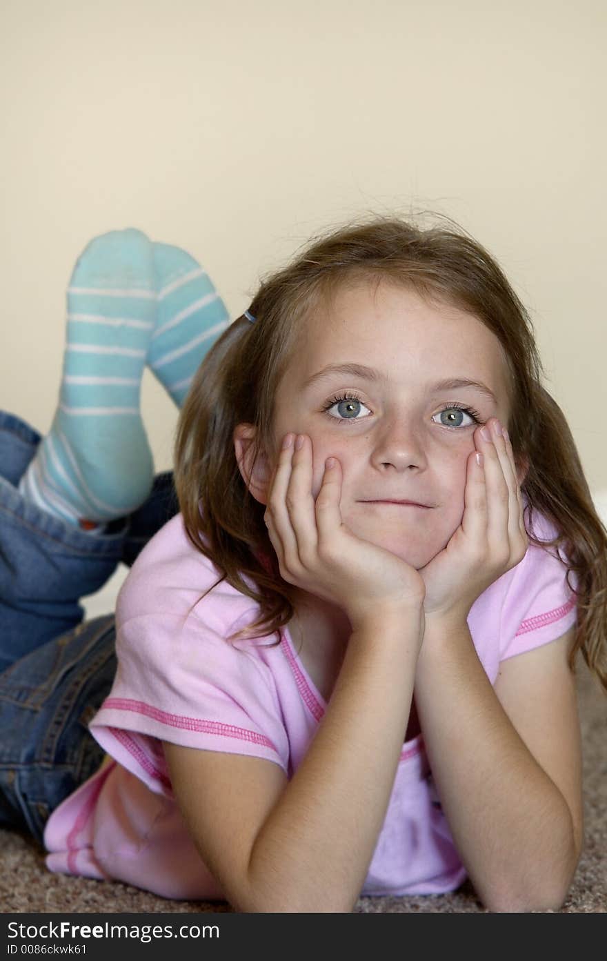 Young girl leaning on hands thinking