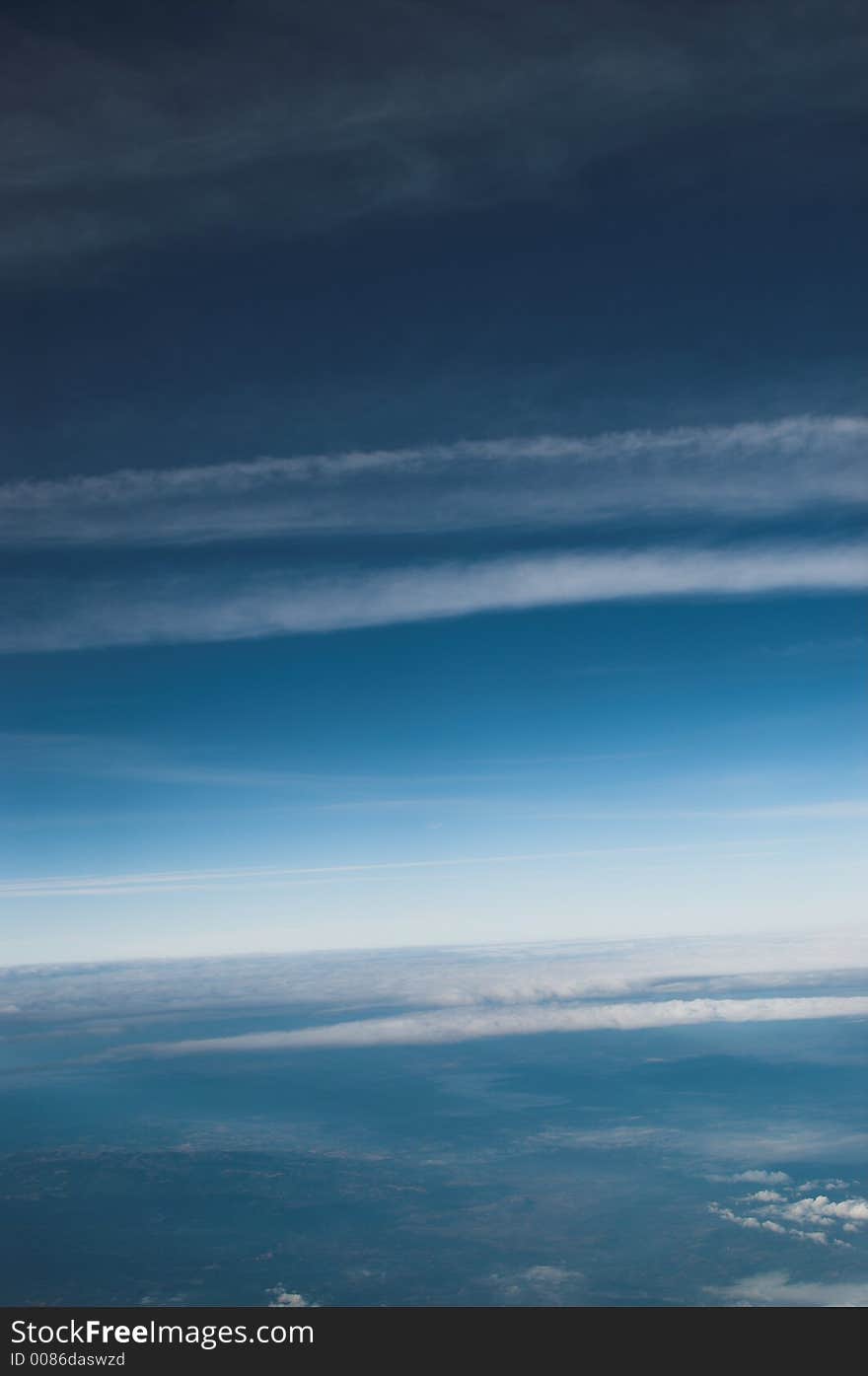 Airplane condens above the European Alps seen from an airplane at 28.000 feet.