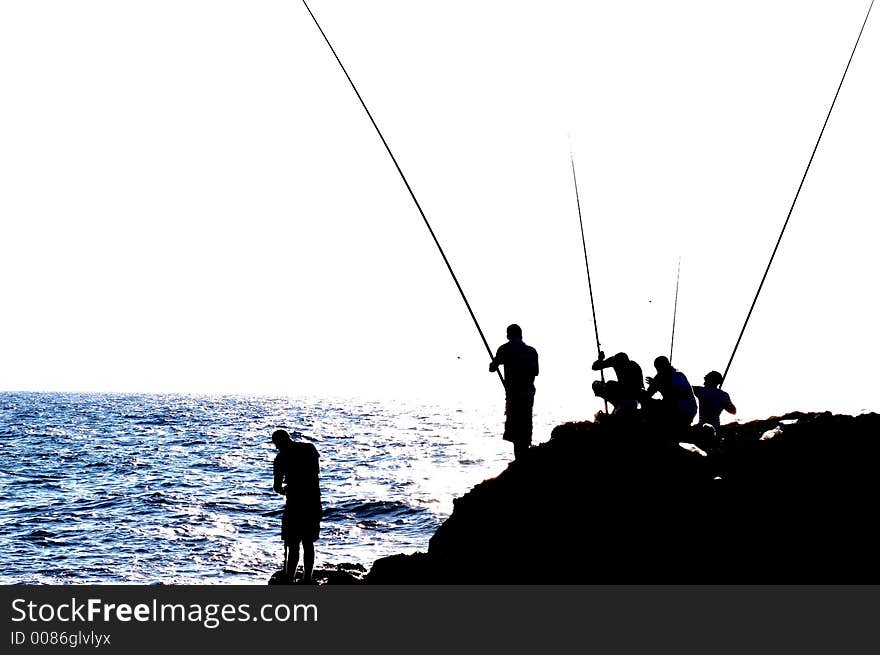 Fishers silhouette in Keisaria antique port , israel