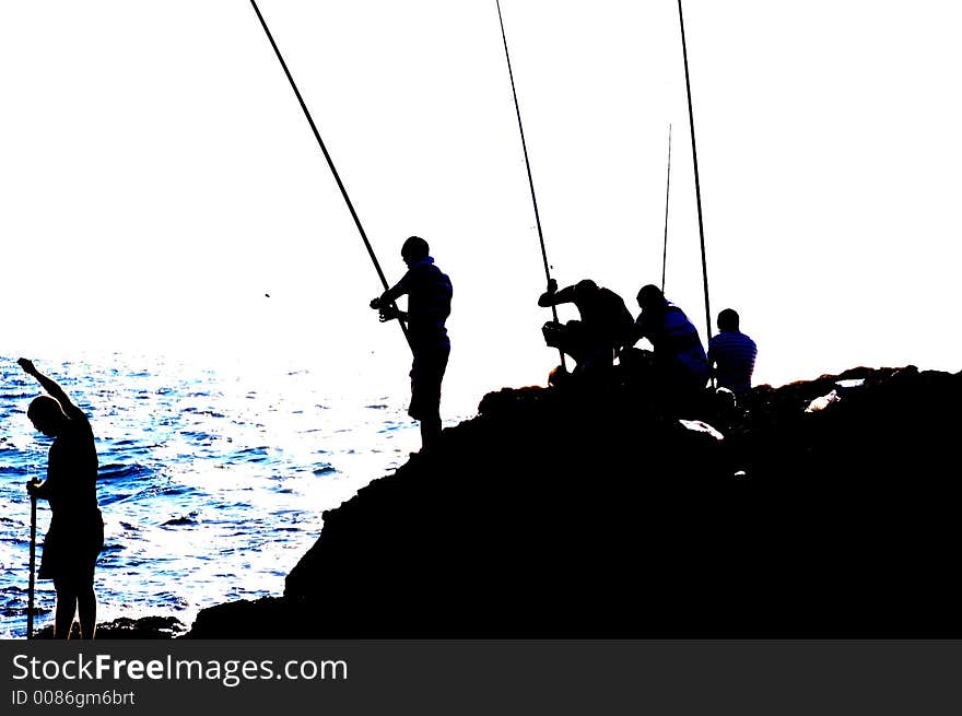 Fishers silhouette in Keisaria antique port , israel