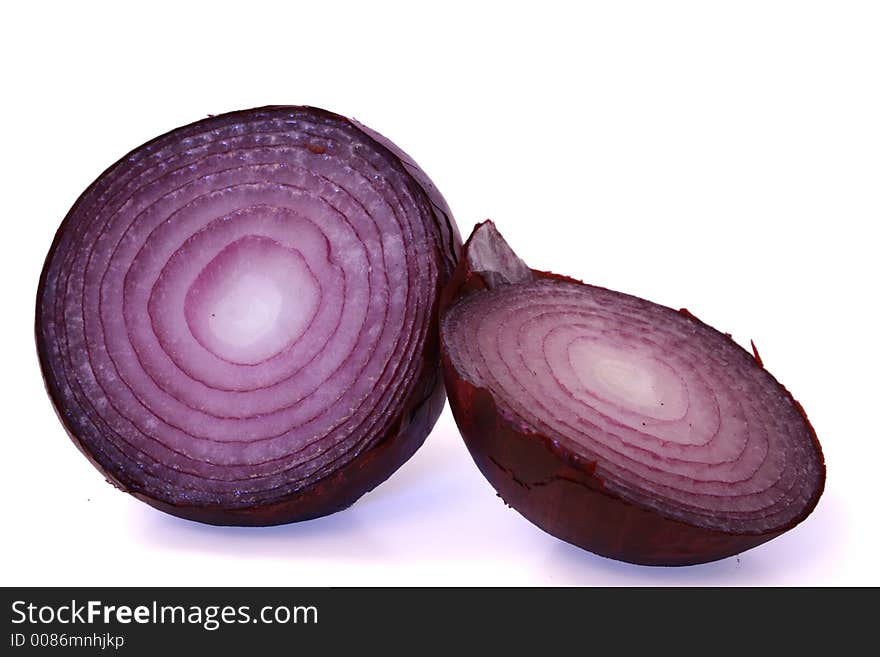 A red onion cut in half and isolated on white background.