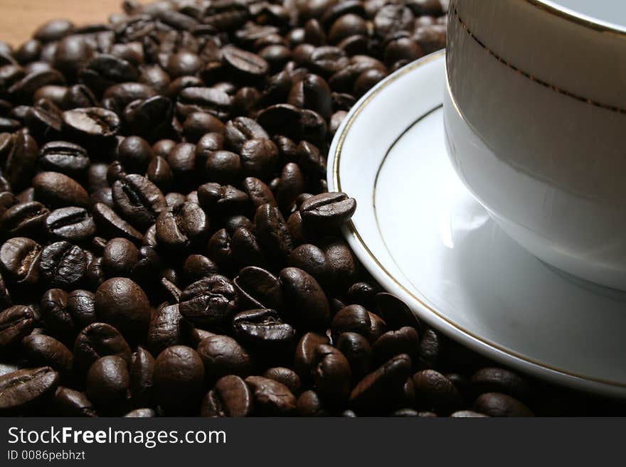 Cup of coffee on a background of fried coffee grains. Cup of coffee on a background of fried coffee grains