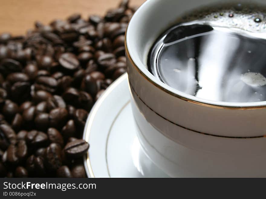 Cup of coffee on a background of fried coffee grains. Cup of coffee on a background of fried coffee grains