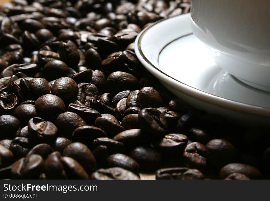 Cup of coffee on a background of fried coffee grains. Cup of coffee on a background of fried coffee grains