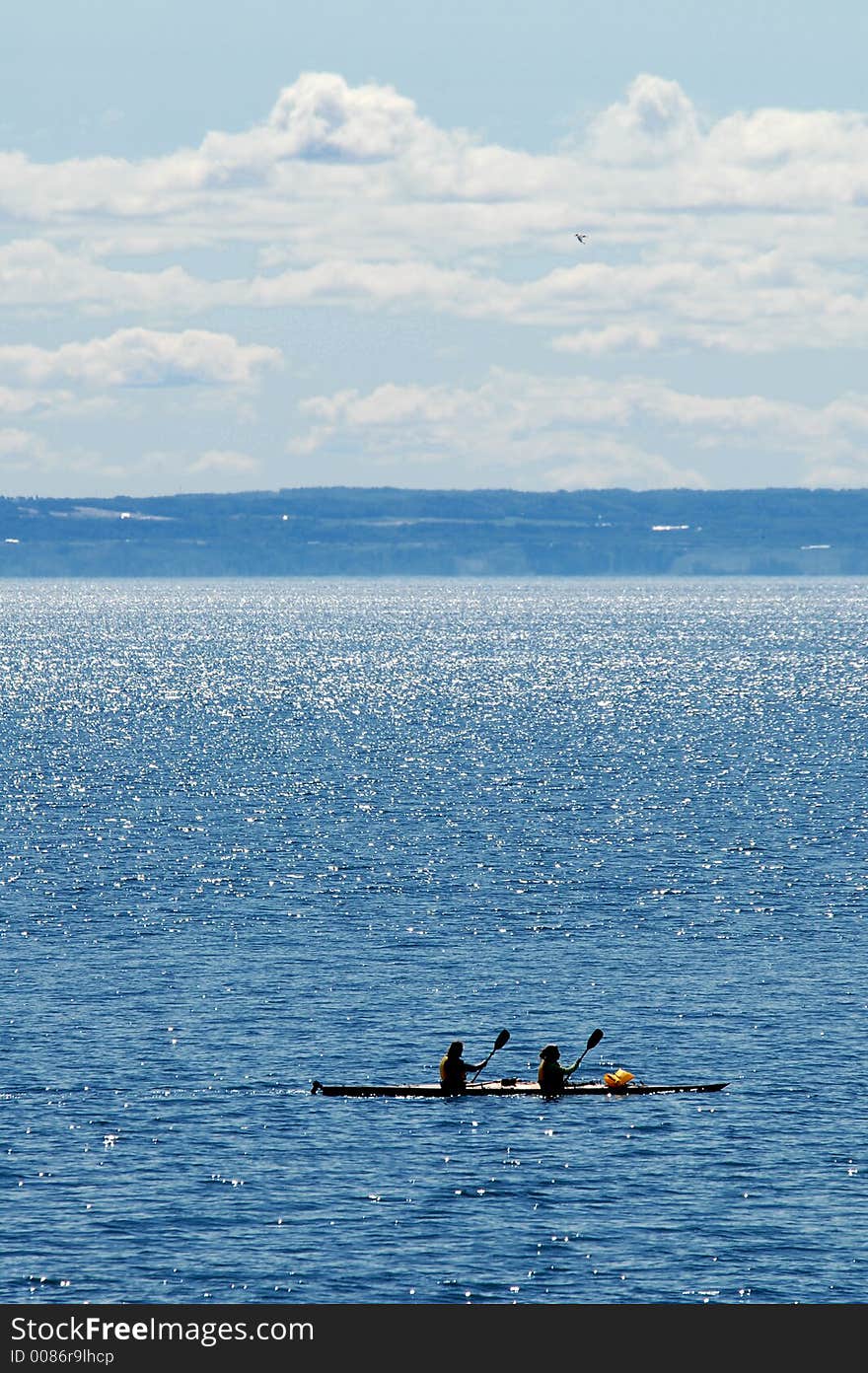 Couple in kayak on blue water. Couple in kayak on blue water