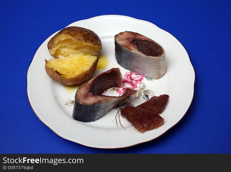 Sliced herring, cavair and potato on a plate. Sliced herring, cavair and potato on a plate