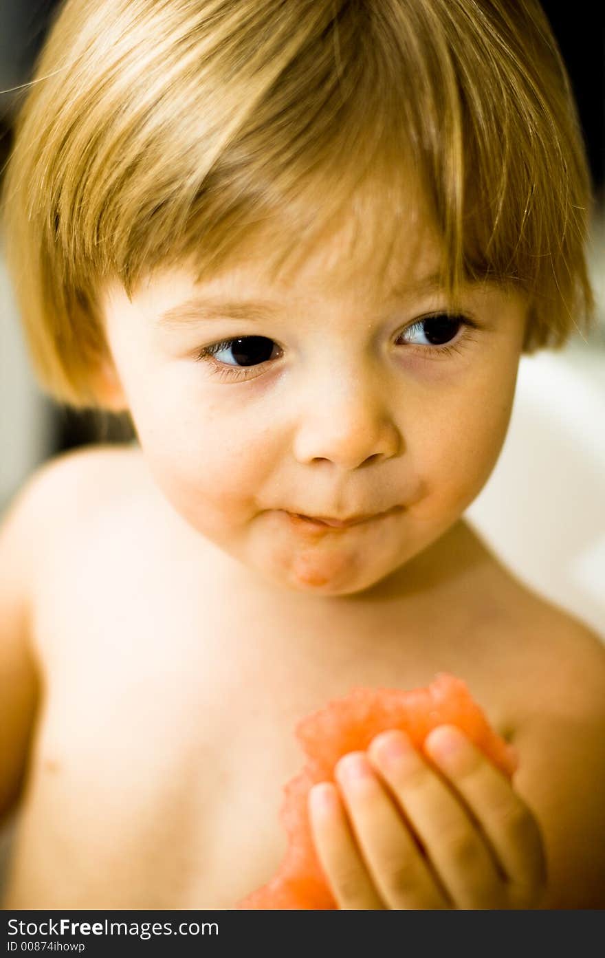 Young child eating a watermelon