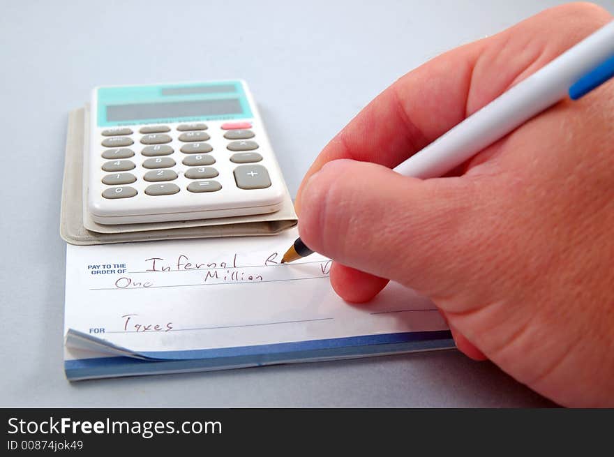 Writing a check for taxes. Writing a check for taxes