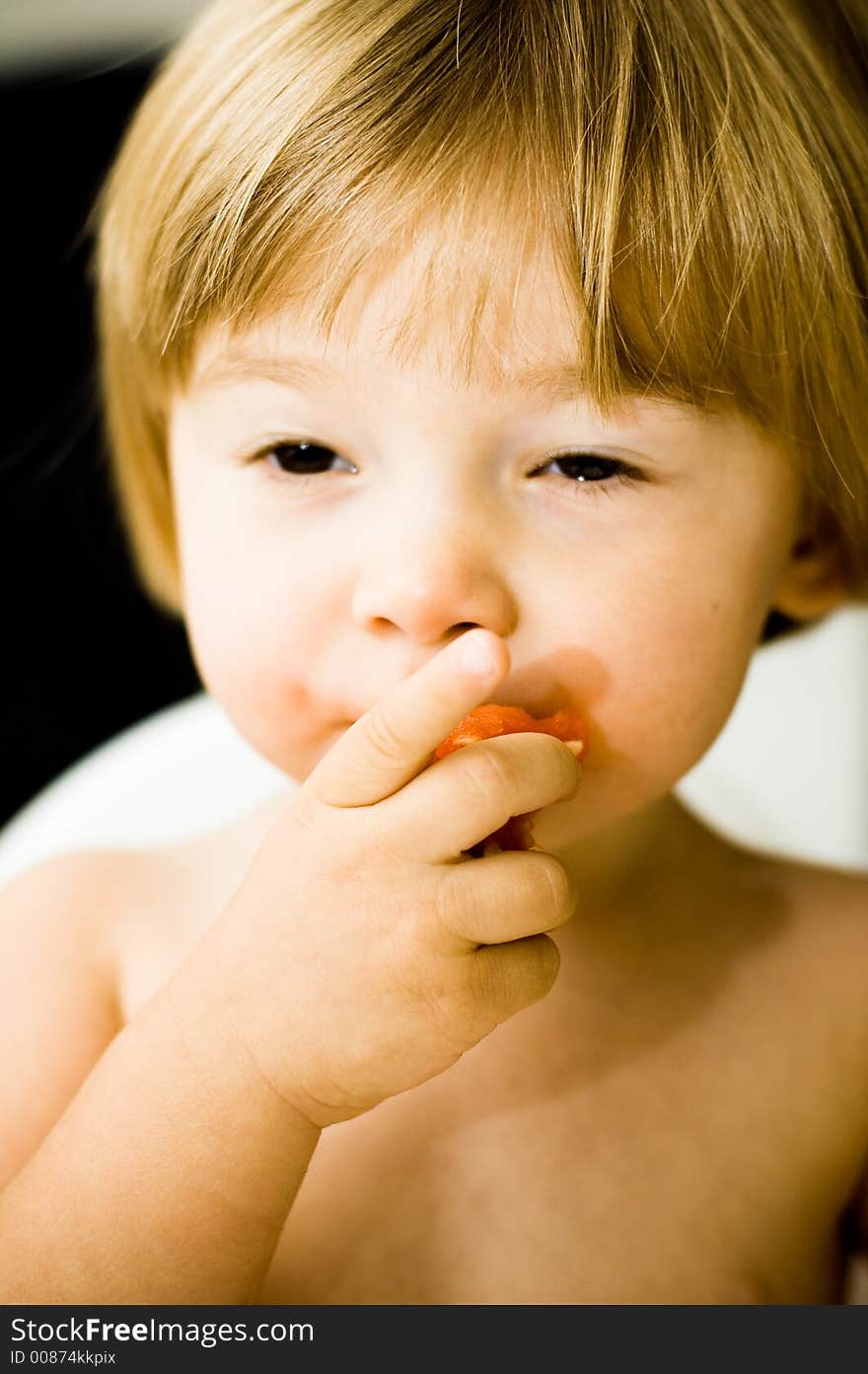 Young child eating a watermelon