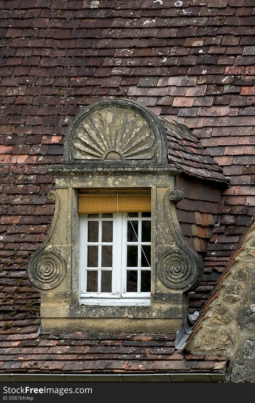 Ancient window and roof in Dordogne, France