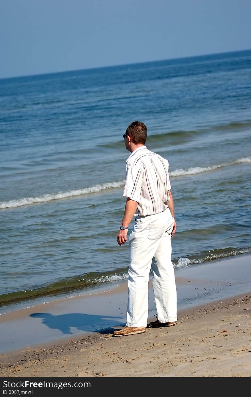 Middleaged man in official clothes standing on the beach. Middleaged man in official clothes standing on the beach