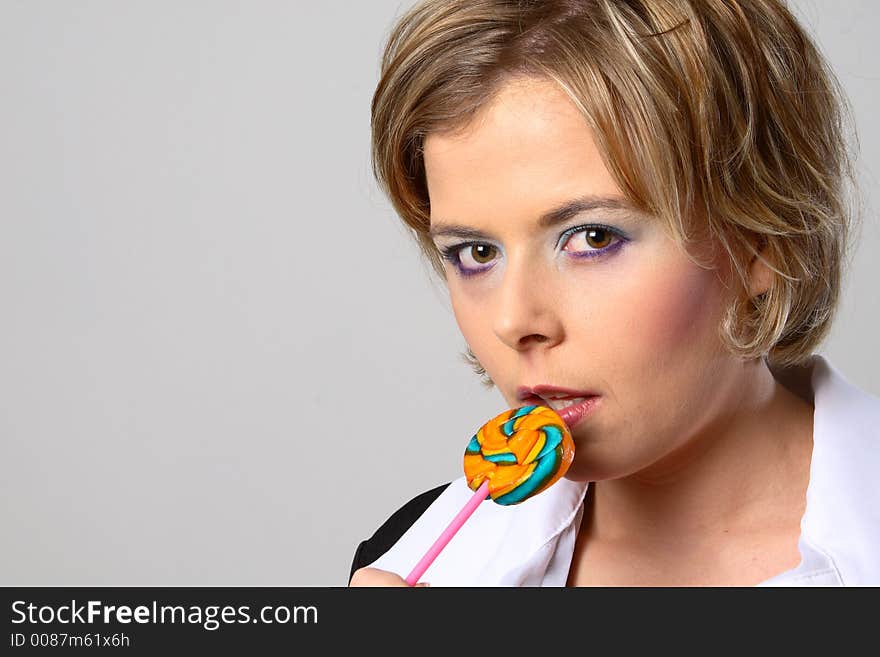 Blond woman with multi-coloured lollipop. Blond woman with multi-coloured lollipop