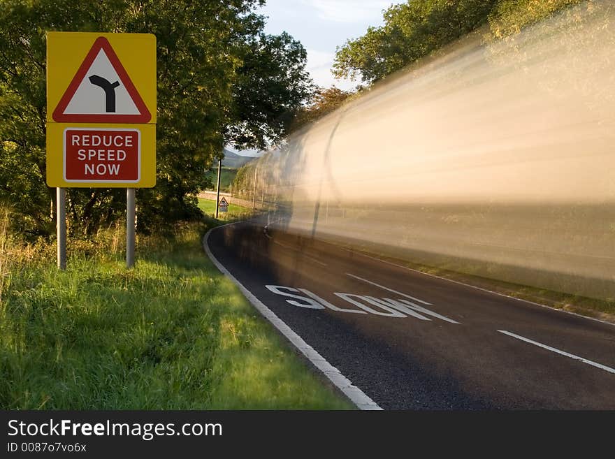 Wagon trundles past reduce speed sign. Wagon trundles past reduce speed sign