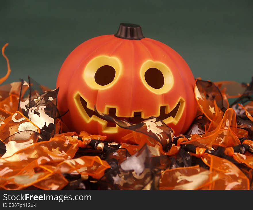 Fun Halloween Punkin surrounded by orange and black printed fabric on green