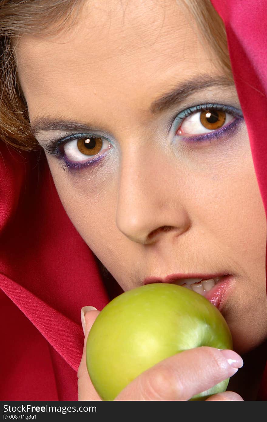 Closeup of woman in red scarf with apple