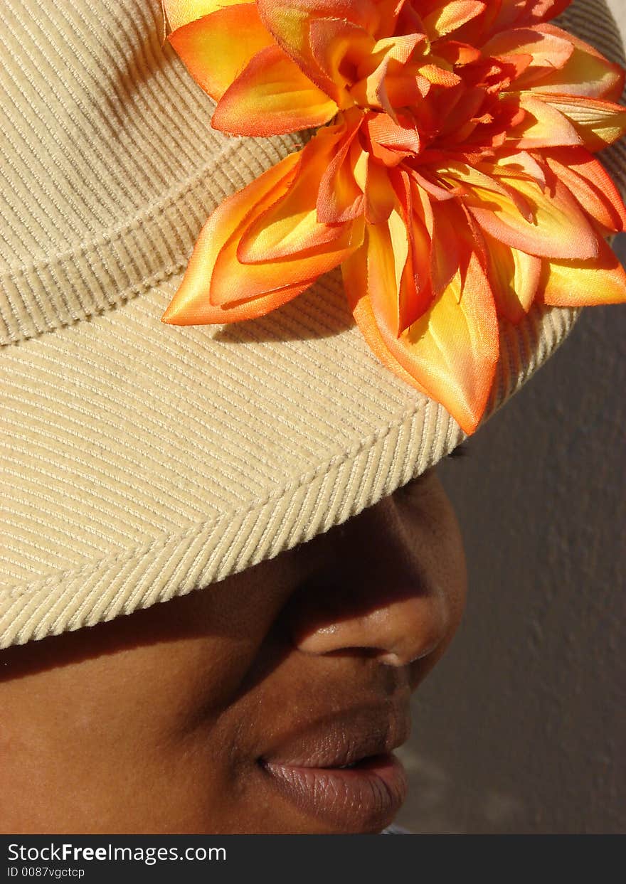 African Lady with Hat and Orange Flower. African Lady with Hat and Orange Flower