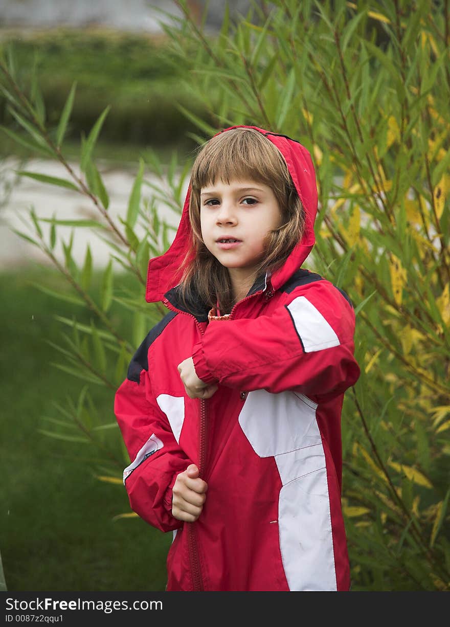 Girl in red jacket in autumn