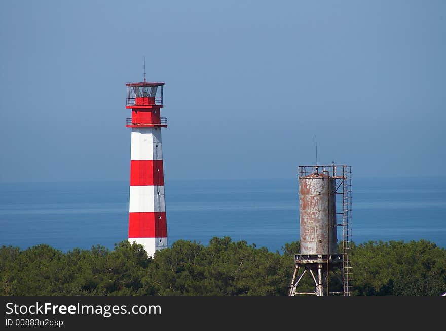 Beacon in a red strip with a water tower in the foreground. Beacon in a red strip with a water tower in the foreground