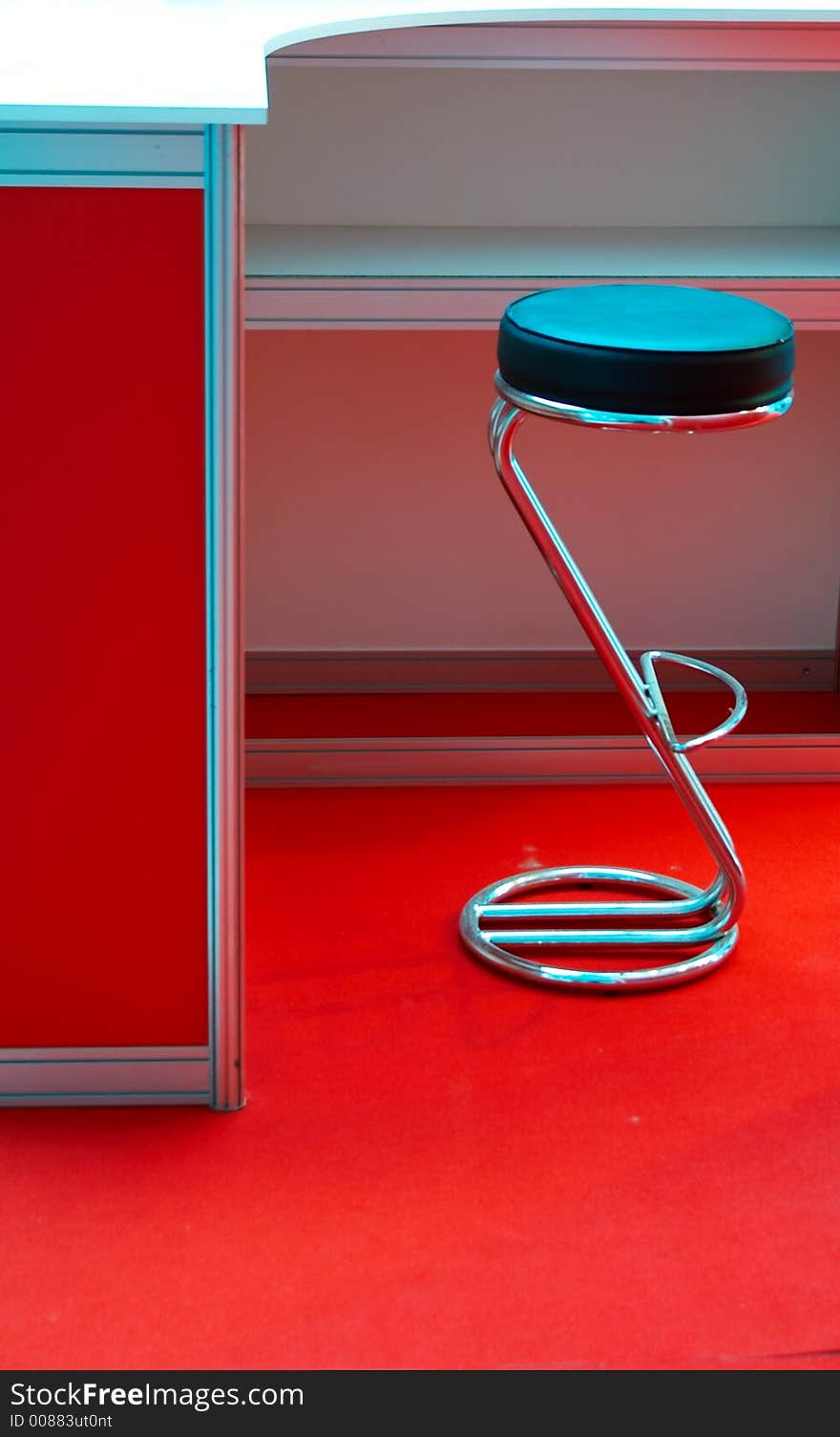 Round metal chair in a red interior