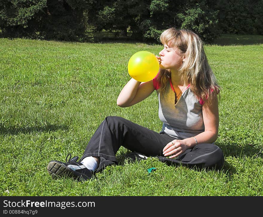 Girl cheats yellow air-ball in  solar daytime. Girl cheats yellow air-ball in  solar daytime