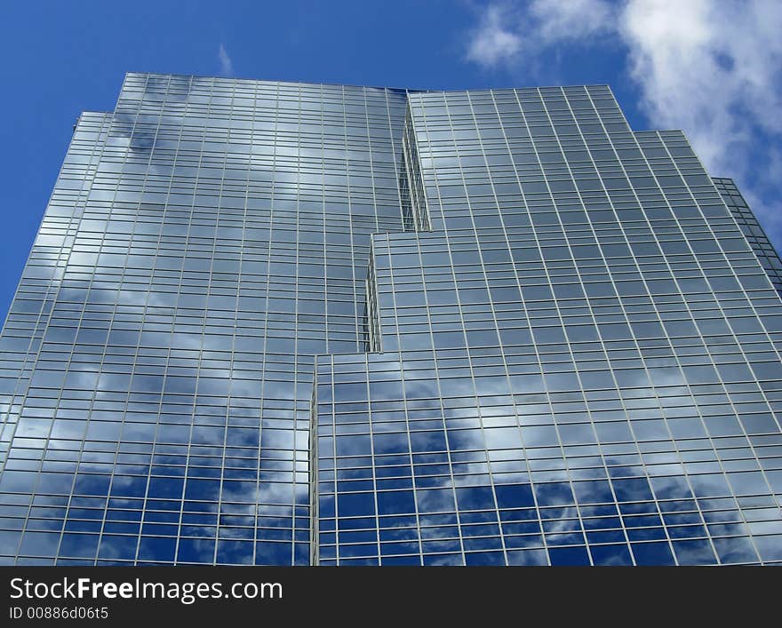 Clouds reflecting in the glass of an office tower. Clouds reflecting in the glass of an office tower.