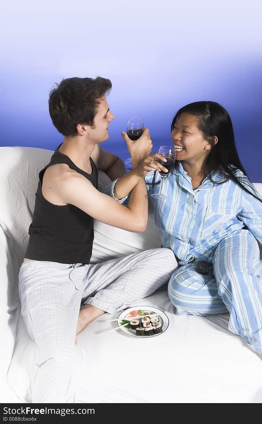 Couple drinking wine over blue background