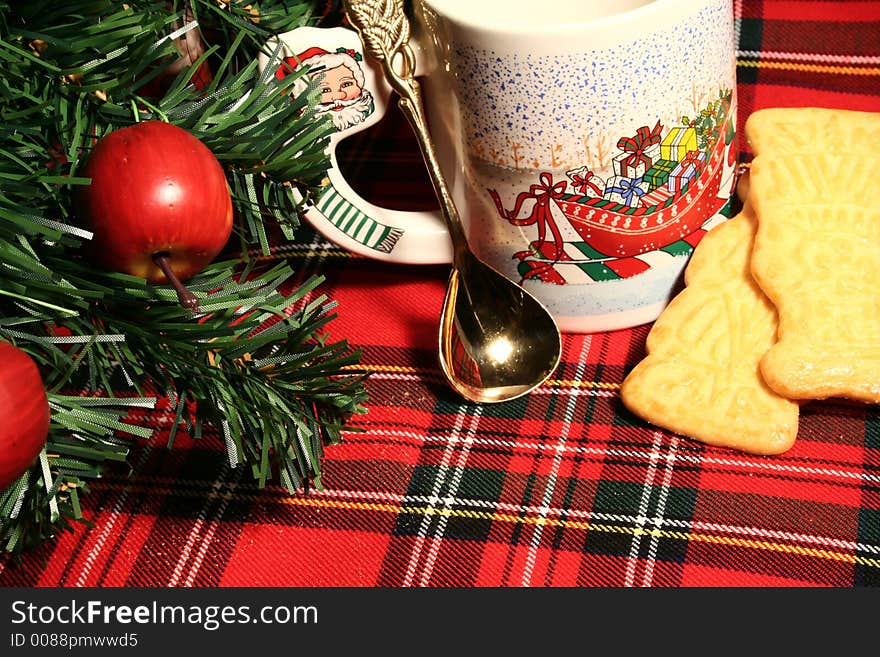 Still life with a cup, spoon, cake, decoration on a chequered stuff. Still life with a cup, spoon, cake, decoration on a chequered stuff