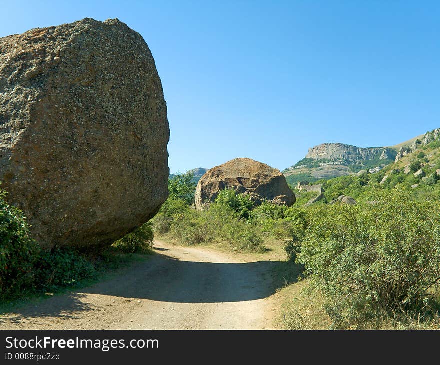 Rock and shadow in road