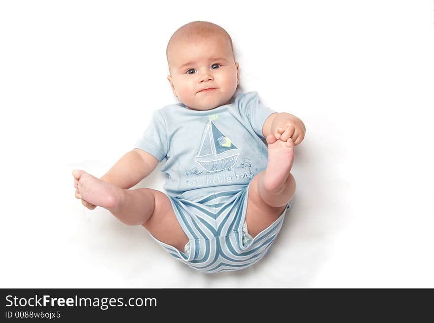 Baby in blue t-shirt playing. Baby in blue t-shirt playing