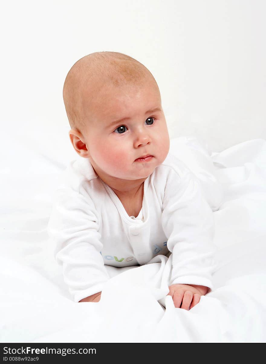 Serious baby on a bed. Serious baby on a bed