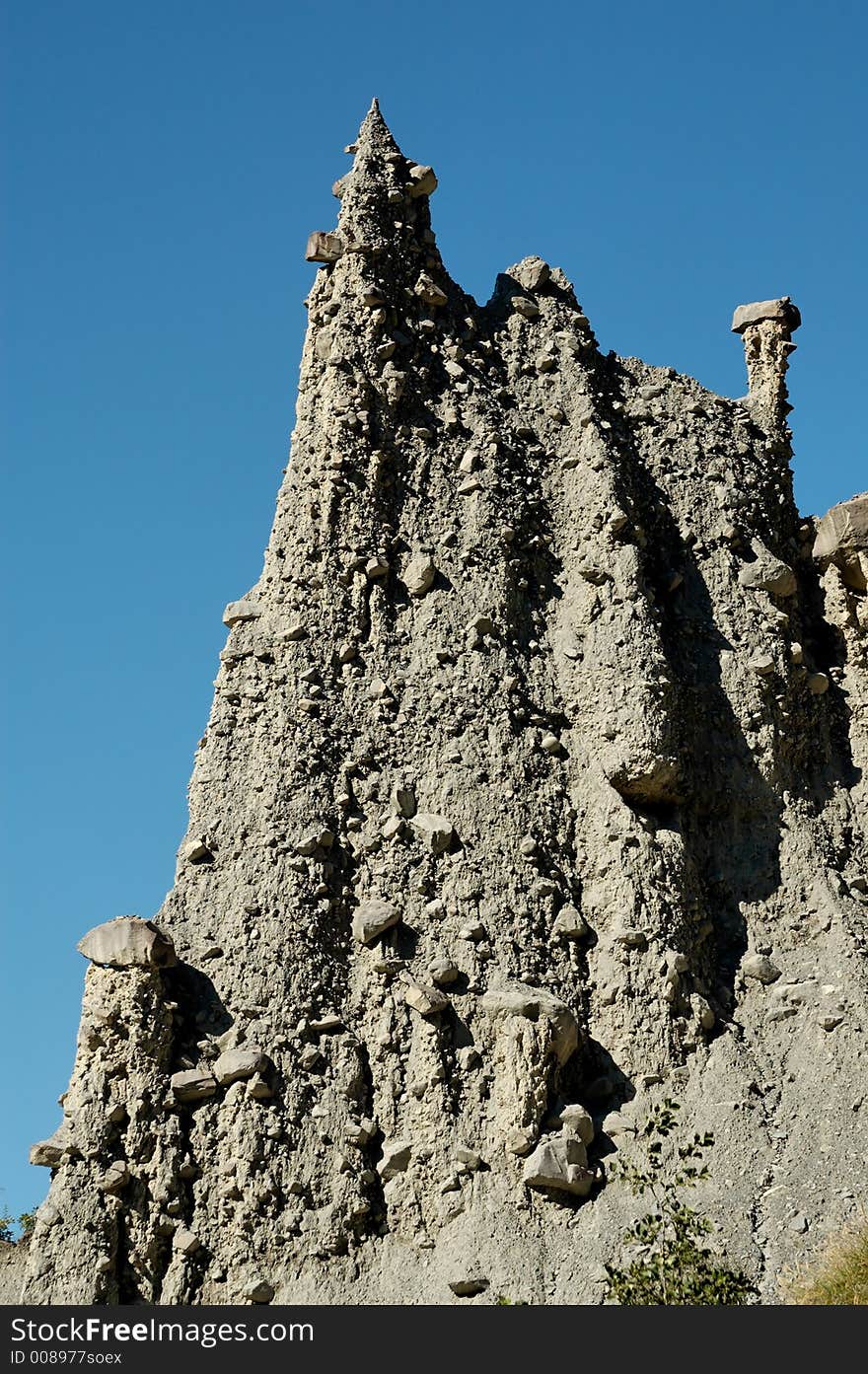 The Demoiselles Coiffées (approximate translation: young ladies with fancy hair or nice hat) is a striking set of narrowly-tapered rock columns standing along the top of a crumbly rock ridge. Each column is topped with a large rock balanced neatly on the tip, helping to protect the demoiselle from complete erosion. The Demoiselles Coiffées (approximate translation: young ladies with fancy hair or nice hat) is a striking set of narrowly-tapered rock columns standing along the top of a crumbly rock ridge. Each column is topped with a large rock balanced neatly on the tip, helping to protect the demoiselle from complete erosion.