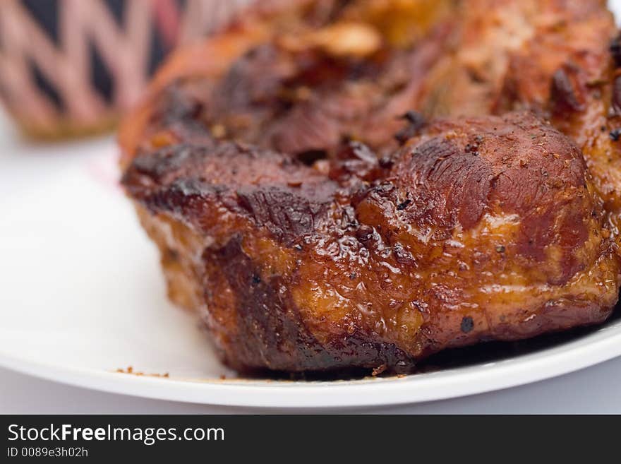 Baked in foil with honey pork meat and a bottle of wine, close-up. Baked in foil with honey pork meat and a bottle of wine, close-up.