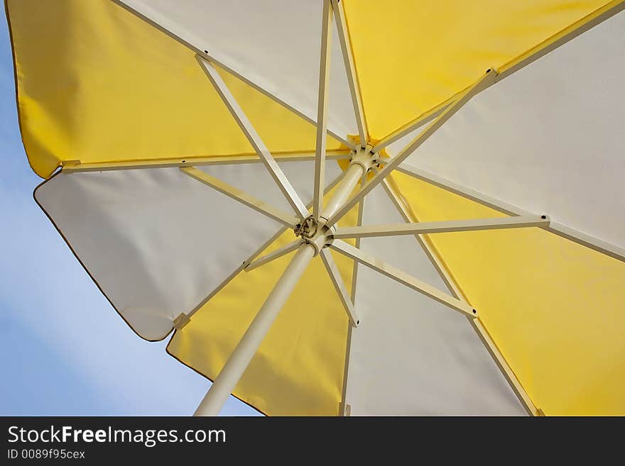 Sunshade in white and yellow against the sky