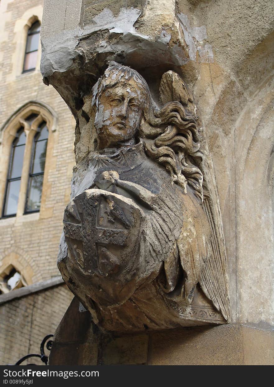 Stone carving of angel on doorarch bearing shield. Stone carving of angel on doorarch bearing shield