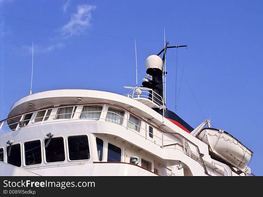 Top of a cruise ship showing command tower, radar and lifeboat. Top of a cruise ship showing command tower, radar and lifeboat