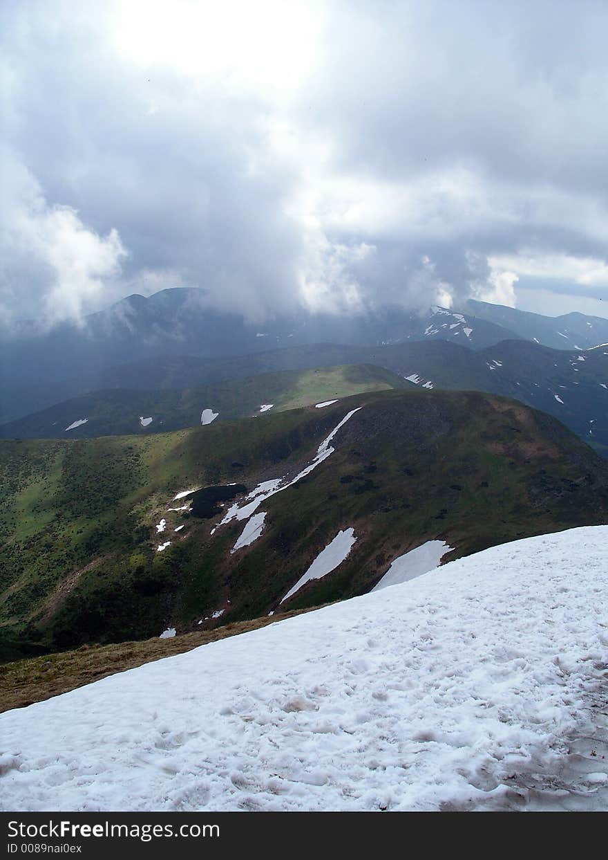 View from the top of Hoverla (the highest mountain in the Ukrainian part of Carpathians) where Snow covers the ground in the heart of summer (dated 25.06.2006). View from the top of Hoverla (the highest mountain in the Ukrainian part of Carpathians) where Snow covers the ground in the heart of summer (dated 25.06.2006)