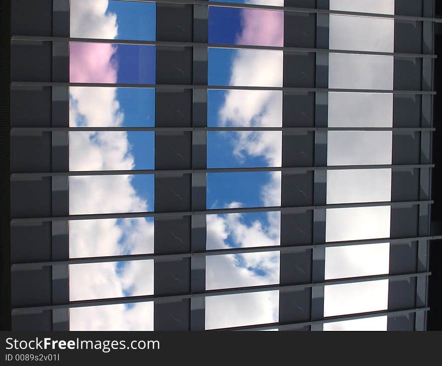 Blue sky and white clouds in the windows of a building. Blue sky and white clouds in the windows of a building