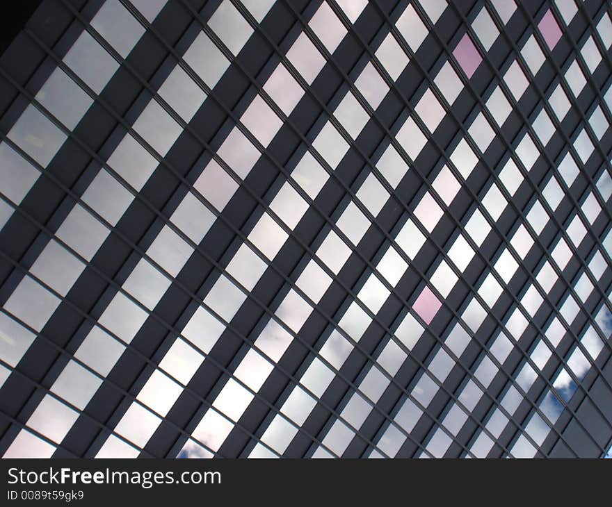 The reflection of the sky in the windows of a building. The reflection of the sky in the windows of a building