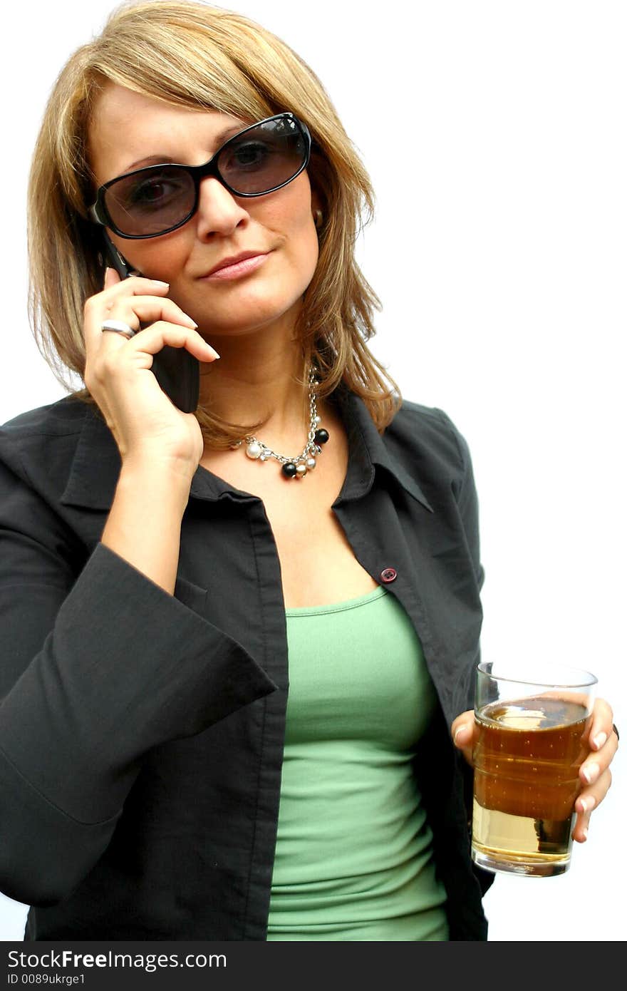 A beautiful Woman with a mobile phone and an glass. A beautiful Woman with a mobile phone and an glass.